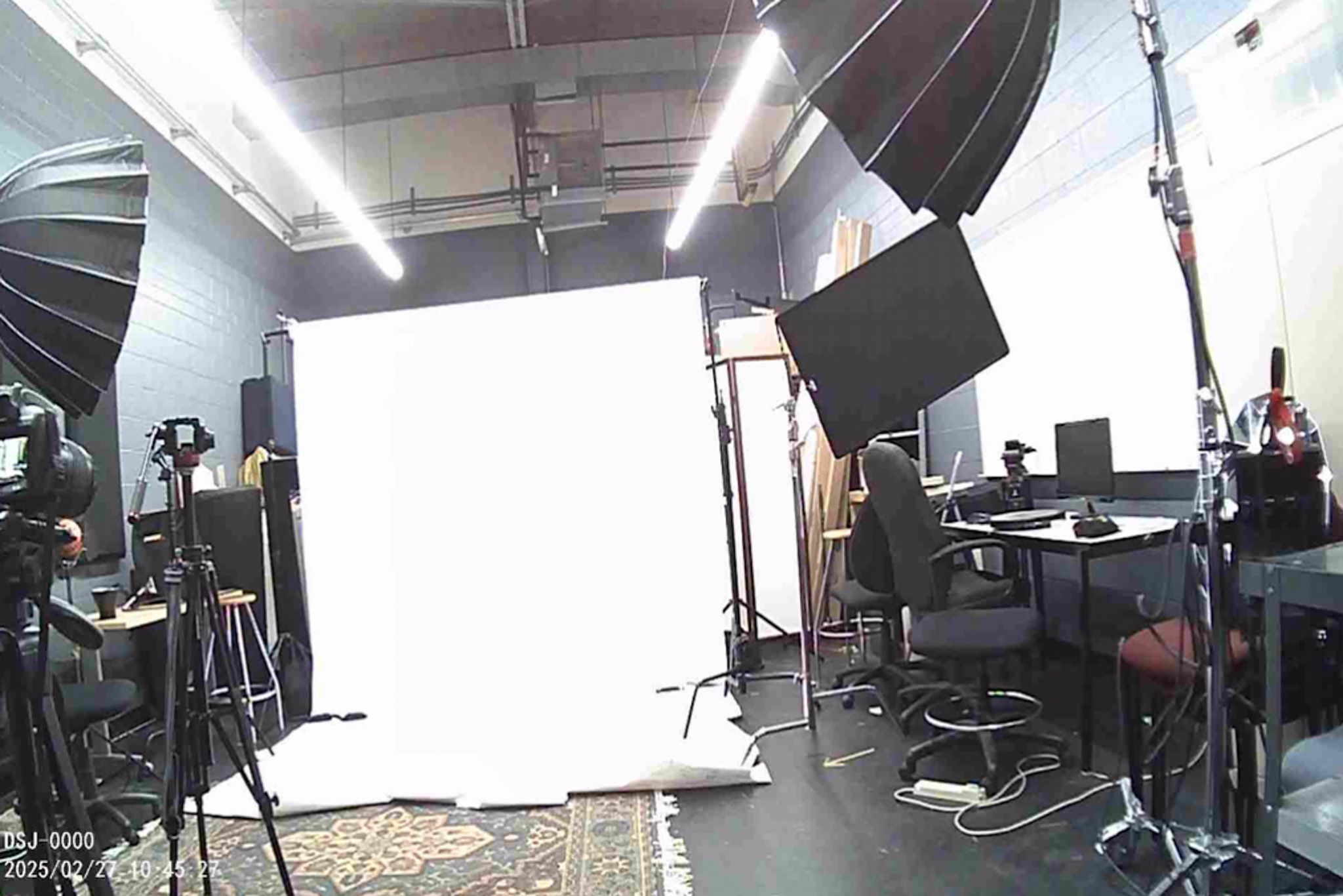 Photography studio with lighting equipment and a backdrop